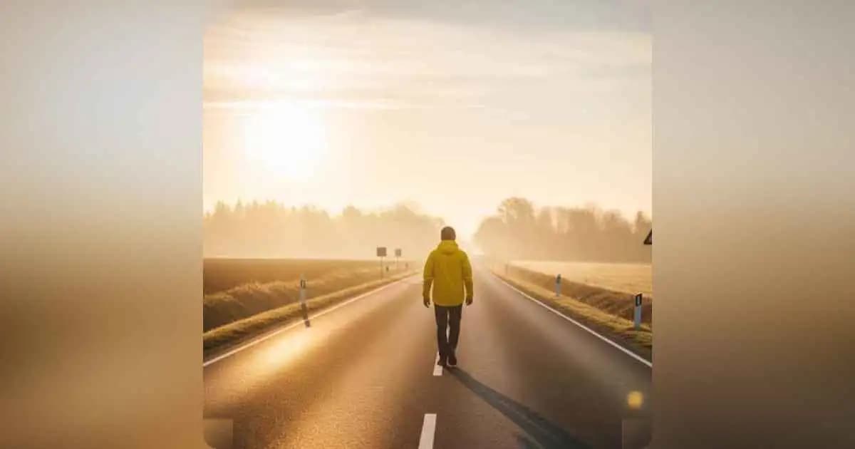 A person walking alone on a quiet road at sunrise, symbolizing freedom, healing, and a fresh start