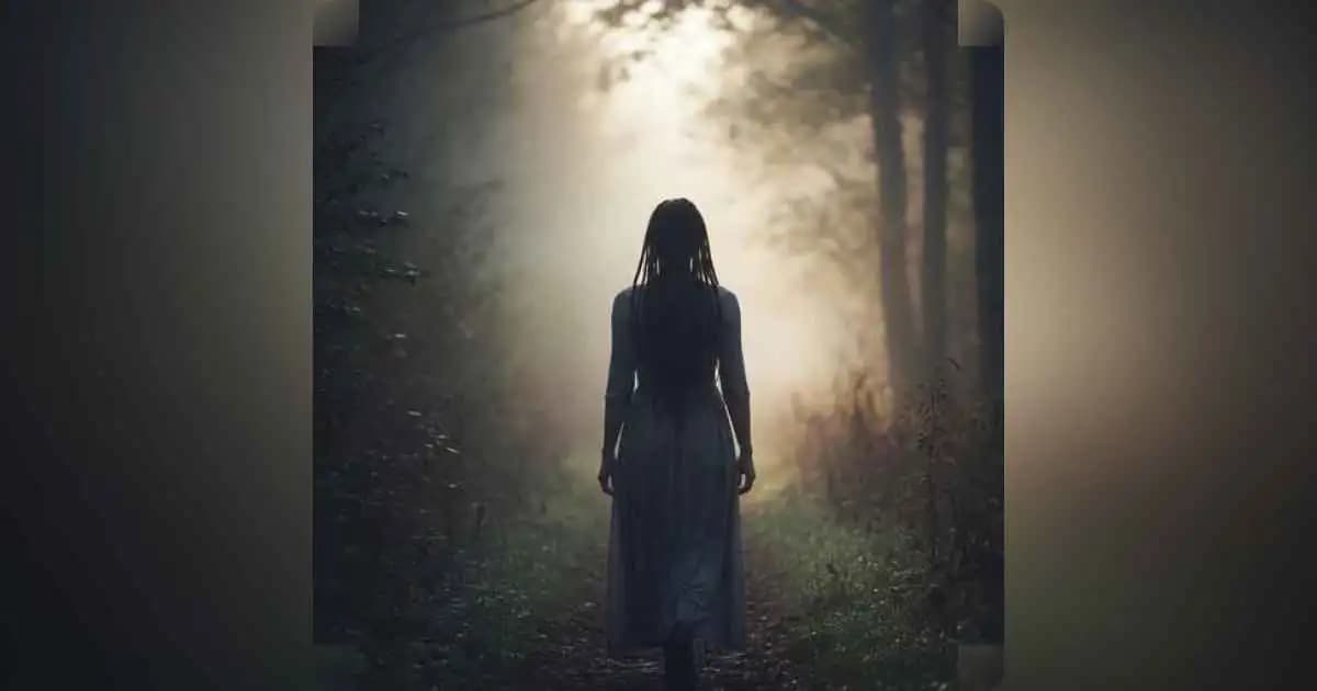 A person walking alone on a foggy path, symbolizing self-discovery