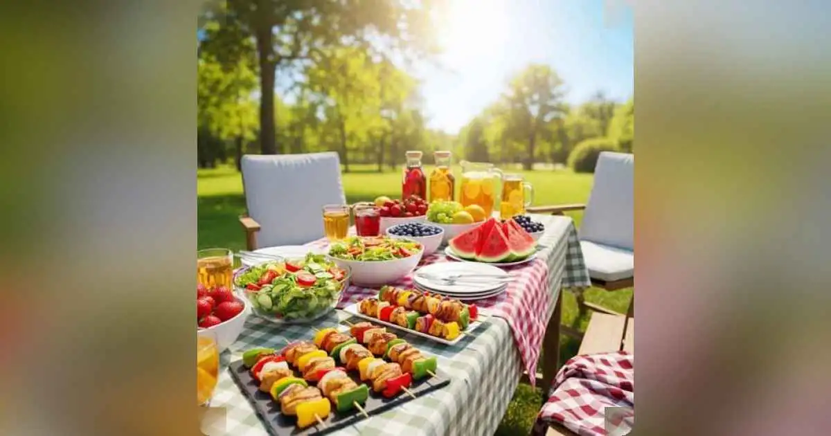 Fresh summer salad with colorful vegetables and grilled chicken skewers on a picnic table