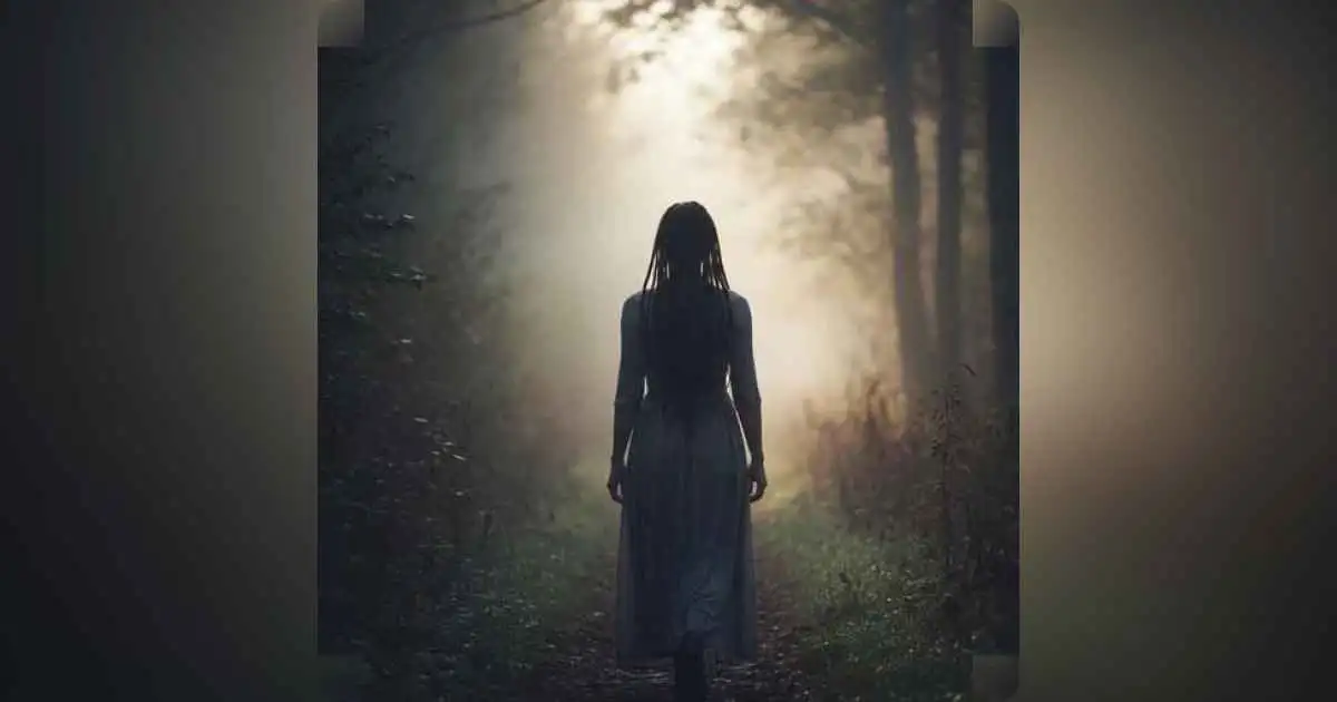 A person walking alone on a foggy path, symbolizing self-discovery